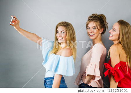 Fashionable women taking selfie Fashionable women taking selfie 135251601