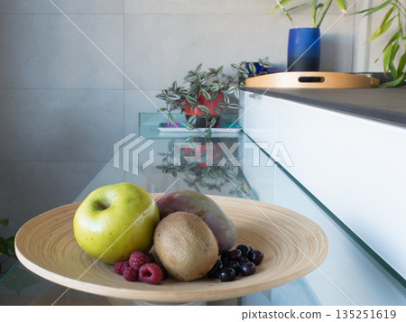 Fruiterer with fresh fruit: apple, mango, kiwi, rapberries and blueberries Fruiterer with fresh fruit: apple, mango, kiwi, rapberries and blueberries 135251619