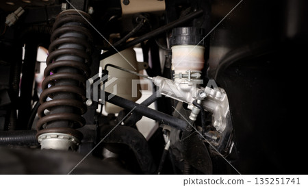 Old car suspensions. Close up car suspension wear and tear parts. CV joint Rubber boot and Control arms bushing Steering rack axles Shock absorber Brake exhaust. Gas Diesel car service repair parts. 135251741