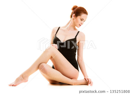 Sitting woman in underwear showing smooth legs Sitting woman in underwear showing smooth legs 135251808
