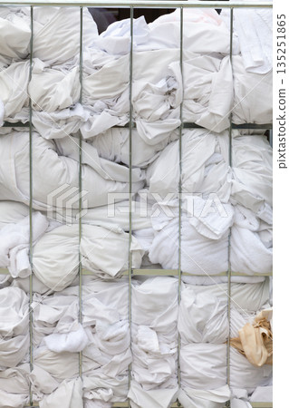 Big metal basket with hotel laundry 135251865