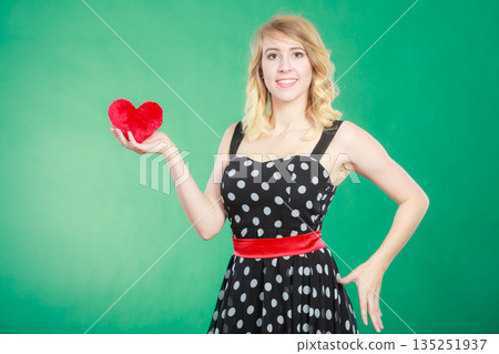 Woman holding red heart love symbol Woman holding red heart love symbol 135251937
