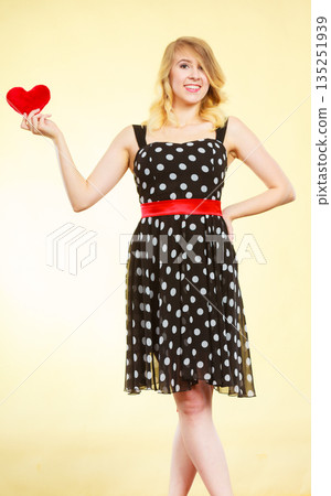 Woman holding red heart love symbol Woman holding red heart love symbol 135251939