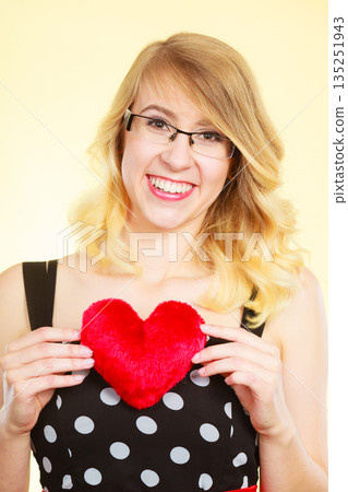 Woman holding red heart love symbol Woman holding red heart love symbol 135251943