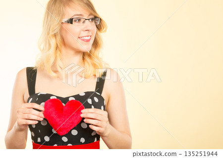 Woman holding red heart love symbol Woman holding red heart love symbol 135251944