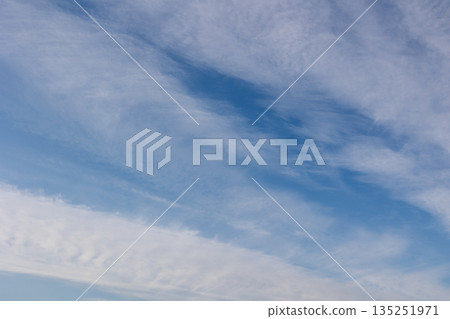 A blue winter sky with streaky clouds A blue winter sky with streaky clouds 135251971