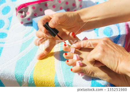 Woman pedicure with red nail polish Woman pedicure with red nail polish 135251980
