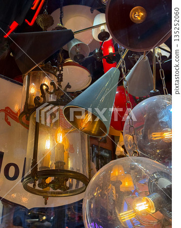 Vintage lamps and chandeliers with warm glowing bulbs. Retro design, nostalgia, and cozy ambiance. Vintage lamps and chandeliers with warm glowing bulbs. Retro design, nostalgia, and cozy ambiance. 135252060