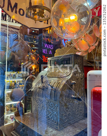 Vintage lamps and chandeliers with warm glowing bulbs. Retro design, nostalgia, and cozy ambiance. 135252062