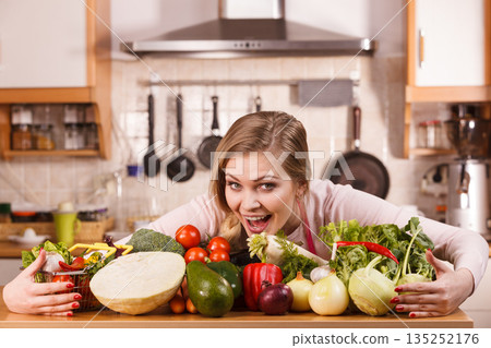 Woman having vegetables on table 135252176
