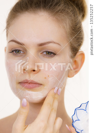 Girl apply cream cosmetic Girl apply cream cosmetic 135252257