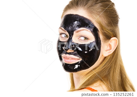 Woman with black peel off mask on face Woman with black peel off mask on face 135252261