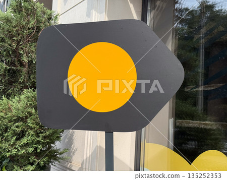 Minimal black signboard with yellow circle on a building facade, copy space. Modern branding, abstract logo design, and storefront visual identity Minimal black signboard with yellow circle on a building facade, copy space. Modern branding, abstract logo design, and storefront visual identity 135252353