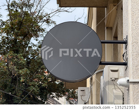 Blank round signboard mounted on a building facade outdoors., copy space and empty place for advertising. Business branding, minimal signage, and urban storefront identity Blank round signboard mounted on a building facade outdoors., copy space and empty place for advertising. Business branding, minimal signage, and urban storefront identity 135252355
