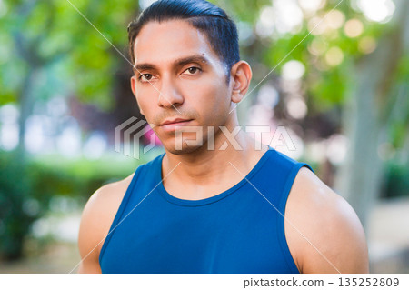 Determined hispanic male athlete portrait in park 135252809
