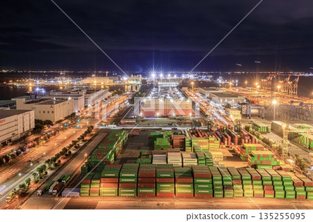 Night view of the Aomi Container Terminal from the Telecom Center in Odaiba and the light trails of planes taking off and landing at Haneda Airport 135255095