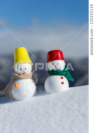 Fresh snow and a pair of snowmen 135255119