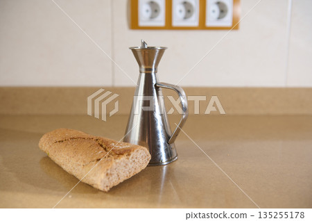 Bread Loaf And Metal Coffee Pot On Kitchen Counter In A Simple Food Scene Bread Loaf And Metal Coffee Pot On Kitchen Counter In A Simple Food Scene 135255178