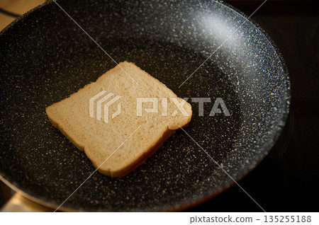 Slice Of White Bread In A Speckled Nonstick Pan For Toasting 135255188