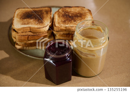 Toasted Bread With Peanut Butter And Jam On Plate For A Cozy Breakfast Spread Toasted Bread With Peanut Butter And Jam On Plate For A Cozy Breakfast Spread 135255196