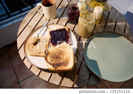 Cozy Breakfast On A Wooden Table With Toast, Jam, Peanut Butter, And Coffee 135255210