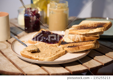 Stack Of Toast With Peanut Butter And Jelly On A Rustic Outdoor Table 135255213