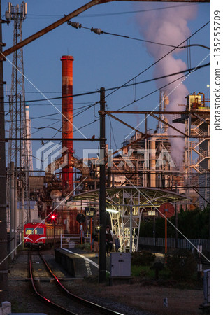 黃昏時分，一列地方火車穿過工業區。 135255709