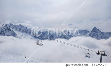 Chairlift above clouds at Dombay ski resort 135255769