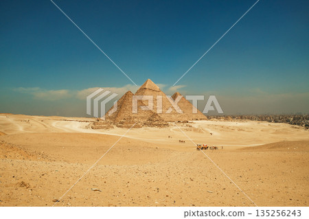 Historic Giza Pyramids Standing Against the Vast Horizon Historic Giza Pyramids Standing Against the Vast Horizon 135256243