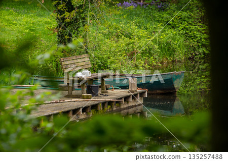Still life with a fisher rowboat tied up to the pier 135257488