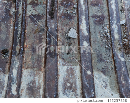 Grungy Metal Texture with Eroded Paint and Rust Streaks Under Natural Light for Abstract Industrial Backgrounds and Design Elements Grungy Metal Texture with Eroded Paint and Rust Streaks Under Natural Light for Abstract Industrial Backgrounds and Design Elements 135257838