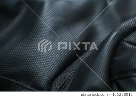 Detailed black nylon fabric texture background for fashion and industrial design, providing a durable and resilient textile option, perfect for sportswear and luggage Detailed black nylon fabric texture background for fashion and industrial design, providing a durable and resilient textile option, perfect for sportswear and luggage 135258015