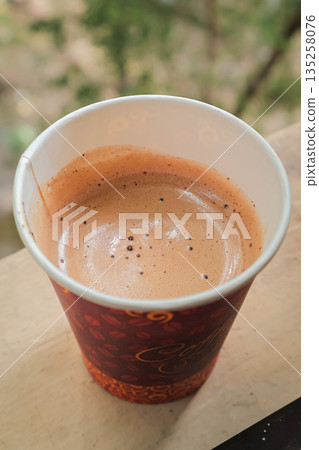 Fresh Espresso in Paper Cup, Natural Light: Enjoying a rich and aromatic espresso in a paper cup on a wooden surface, captured under soft natural light, perfect for coffee break Fresh Espresso in Paper Cup, Natural Light: Enjoying a rich and aromatic espresso in a paper cup on a wooden surface, captured under soft natural light, perfect for coffee break 135258076