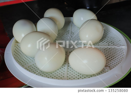 Hard-Boiled Eggs Arranged on Plastic Tray with Natural Light, Fresh and Ready for Breakfast, Salad, or Snack Preparation 135258080