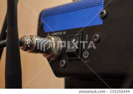 Connector and Switch on Black Device, close-up detailed view of power components and cable connections for industrial equipment use, copy space. Connector and Switch on Black Device, close-up detailed view of power components and cable connections for industrial equipment use, copy space. 135258344