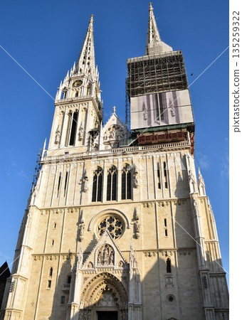 Zagreb Cathedral, a symbol of Zagreb, the capital of Croatia. A neo-Gothic building shining against the blue sky. Zagreb Cathedral, a symbol of Zagreb, the capital of Croatia. A neo-Gothic building shining against the blue sky. 135259322