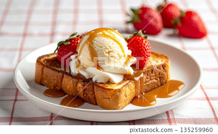 Studio Food Photography of Vanilla Ice Cream Scoop on Thick Toast with Caramel, Whipped Cream and Strawberry 135259960