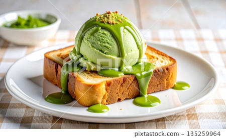 Studio Food Photography of Matcha Ice Cream Scoop on Thick Toast with Matcha Sauce and Whipped Cream 135259964