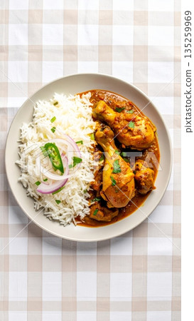 Studio Food Photography of Indian Curry with Spiced Chicken Drumstick and Long Grain Rice, Garnished with Shallots 135259969