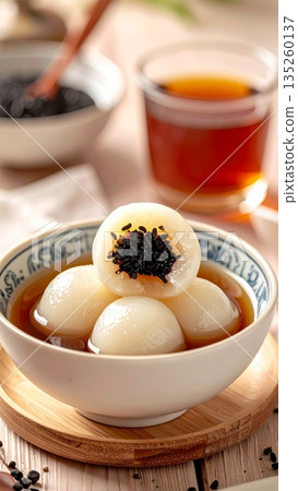 Tangyuan Made from Glutinous Rice with Black Sesame Filling in Ginger Soup or Syrup Tangyuan Made from Glutinous Rice with Black Sesame Filling in Ginger Soup or Syrup 135260137