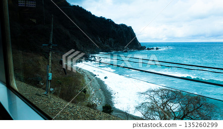 An image of a view of the Sea of Japan in winter from a local train on the Sanin Main Line An image of a view of the Sea of Japan in winter from a local train on the Sanin Main Line 135260299