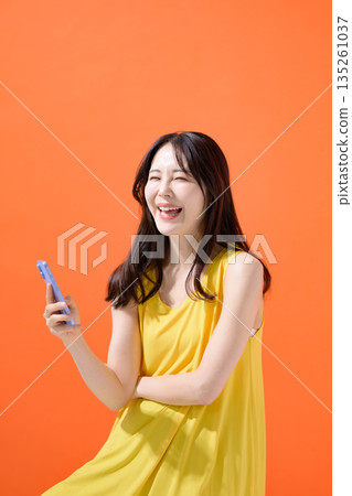 Woman holding a smartphone Woman holding a smartphone 135261037