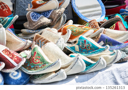 Collection of colorful traditional felt slippers with intricate embroidery Collection of colorful traditional felt slippers with intricate embroidery 135261313