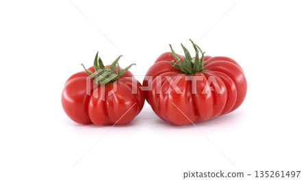 Close-up of two vibrant red heirloom tomatoes, perfect for culinary projects. Close-up of two vibrant red heirloom tomatoes, perfect for culinary projects. 135261497