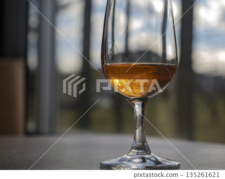 Close-up of amber-colored rosé wine shining in the sunlight Close-up of amber-colored rosé wine shining in the sunlight 135261621