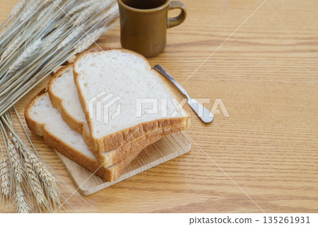 Mountain-shaped bread, coffee, and wheat ears Mountain-shaped bread, coffee, and wheat ears 135261931