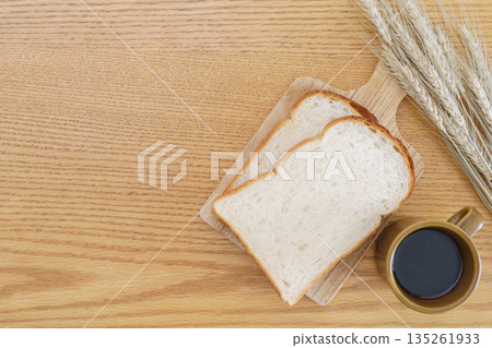 Mountain-shaped bread, coffee, and wheat ears Mountain-shaped bread, coffee, and wheat ears 135261933