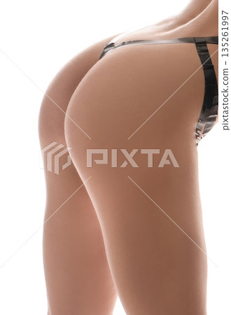 Rear view of woman wearing lingerie on a white background in studio light 135261997