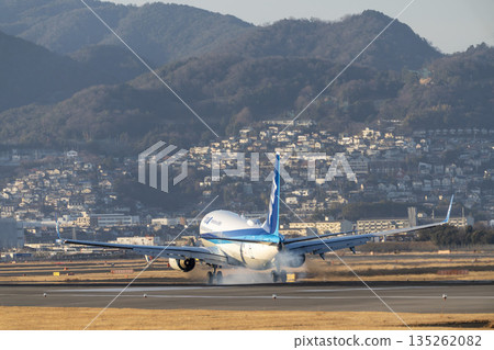 Osaka Airport (Itami Airport) in the evening. A plane is landing. Toyonaka City, Osaka Prefecture. Osaka Airport (Itami Airport) in the evening. A plane is landing. Toyonaka City, Osaka Prefecture. 135262082