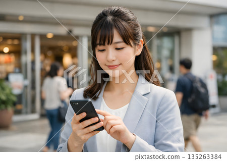 A woman checking her work in the square 135263384